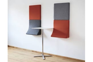 Twee modulaire akoestische wandpanelen in rood en grijs met uitkragende zitgedeelten, geplaatst in een kantooromgeving met kl