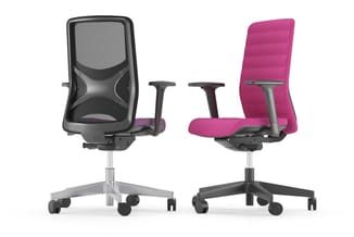 Twee ergonomische bureaustoelen naast elkaar: links zwarte mesh-stoel met grijze accenten, rechts roze/magenta stoel met zwar