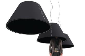 Drie zwarte kegelvormige hanglampen met stitching detail, één met persoon eronder, tegen witte achtergrond.