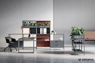 Kantoorwerkplek met grijs bureau, zwarte bureaustoel, modulaire kastenwand met houten en witte vakken, plant op grijs kastje