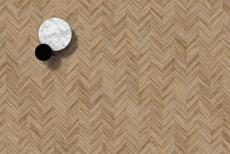 Bovenaanzicht van twee ronde tafels op houten visgraatparket: witte marmeren tafel en zwarte tafel met schaduw.