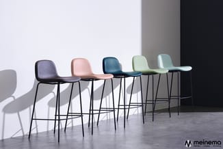 Vijf barstoelen met gekleurde zittingen (paars, roze, donkerblauw, lichtgroen, mintgroen) en zwart metalen frames in moderne